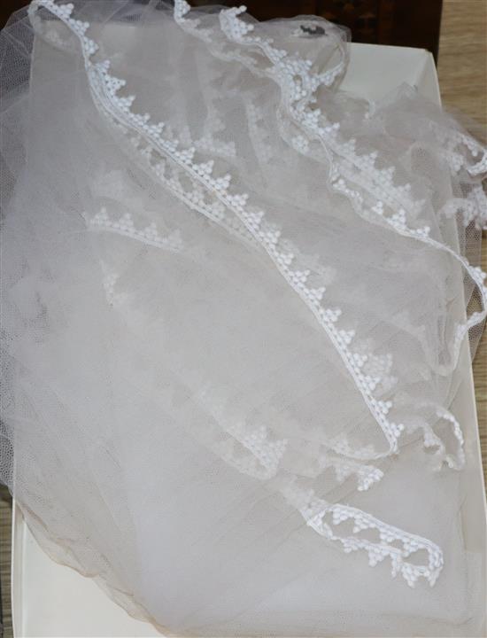 A 1930s white satin wedding dress and later veil